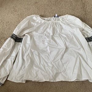 Long too with long sleeves black buttons on the sleeves